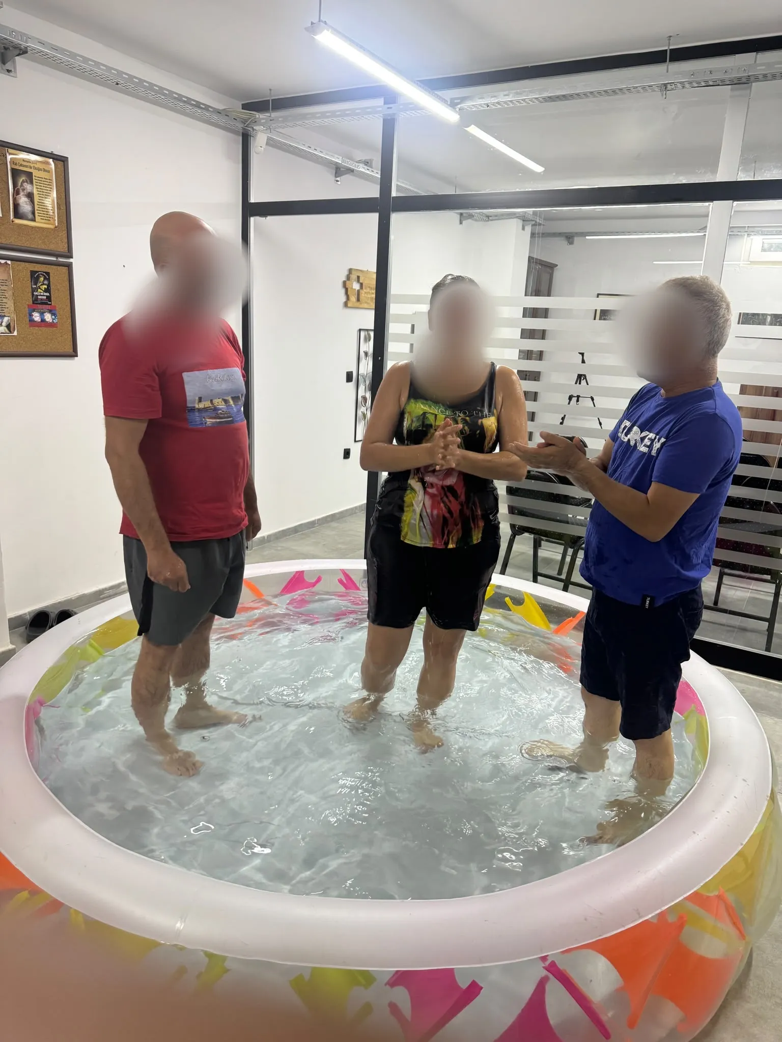 A woman being baptized in the church hall
