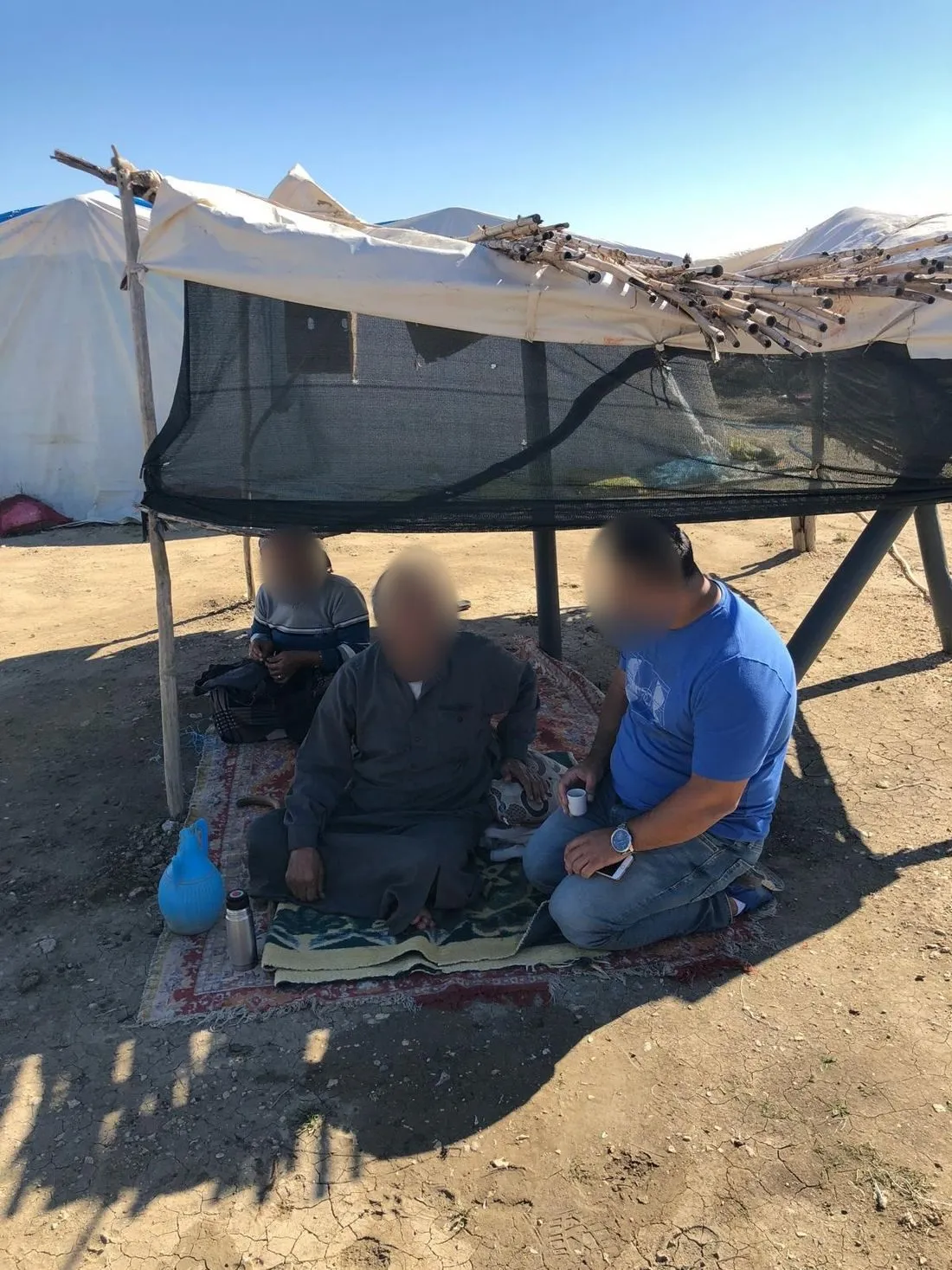 Sharing coffee and conversation under a shelter